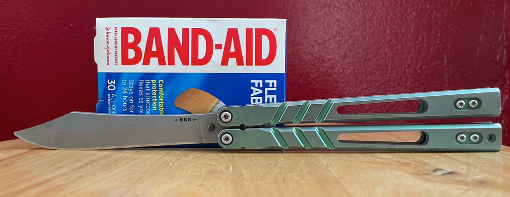 BRS Alpha Beast balisong with a box of band-aids